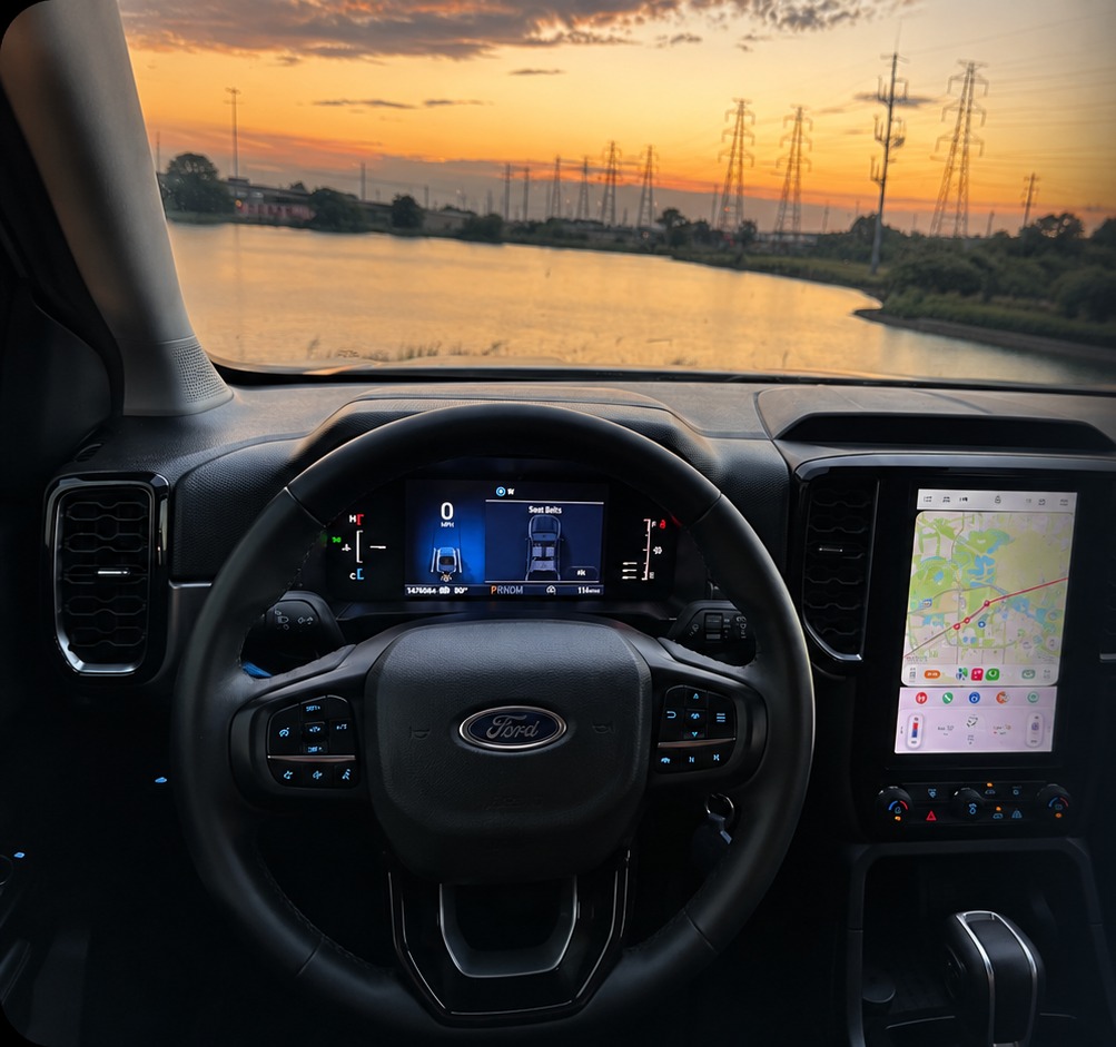 View through a Ford Ranger windshield at sunset over a Dallas lake